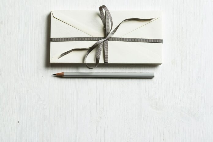 Photo by Joanna Kosinska white envelop and gray pencil on white panel
