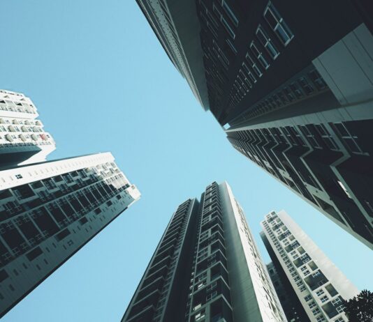 주택 공급 늘리고 세 부담 낮추고 주거 복지는 든든하게 looking up at tall buildings in a city