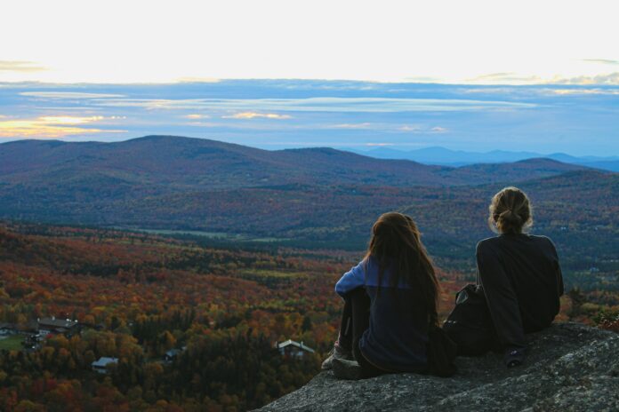 Photo by Brian Yurasits two women sitting on rocks