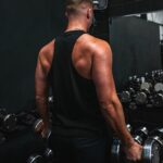 근육 건강 트렌드, 일상 속 작은 변화로 지키자 a man holding a pair of dumbs in a gym