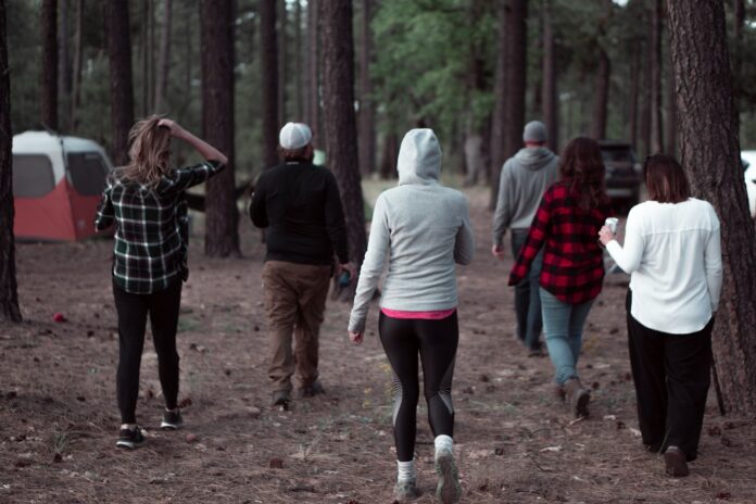 Photo by Gina Santangelo people walking on dirt road during daytime